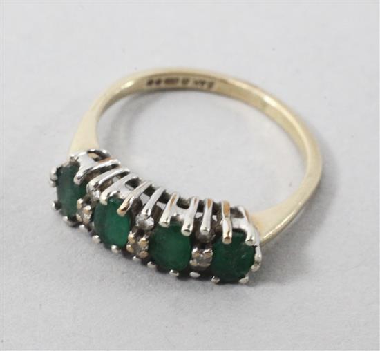 A 9ct gold and emerald half hoop ring, size M.